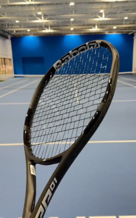 The PP01 on an indoor court: a wider, squarer head than Babolat's usual frames.